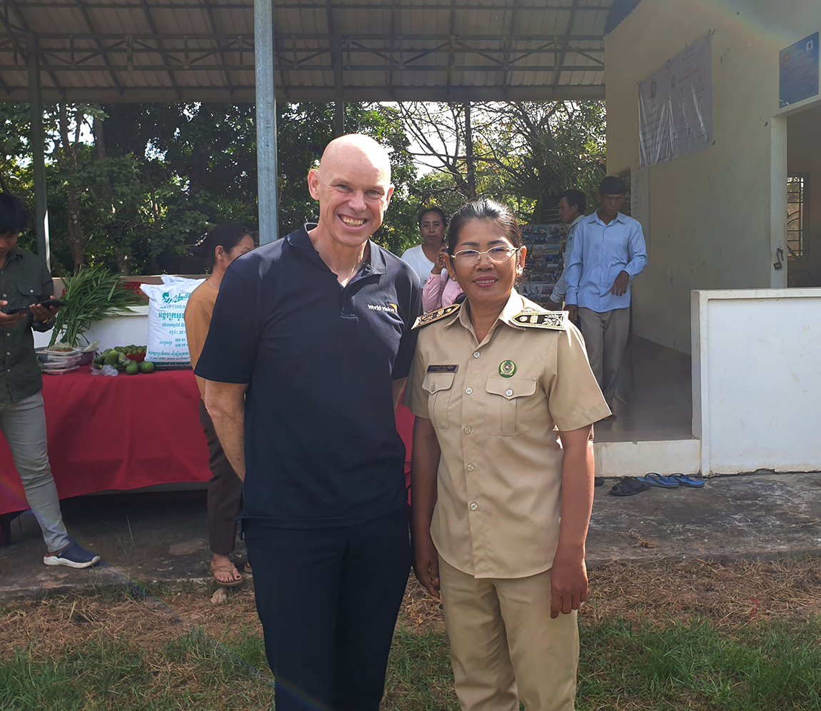 Andrew Morely president and CEO of World Vision International stands with woman who launched an Agriculture Cooperative and went on to become the local mayor in Tbeng Meanchey, Cambodia.