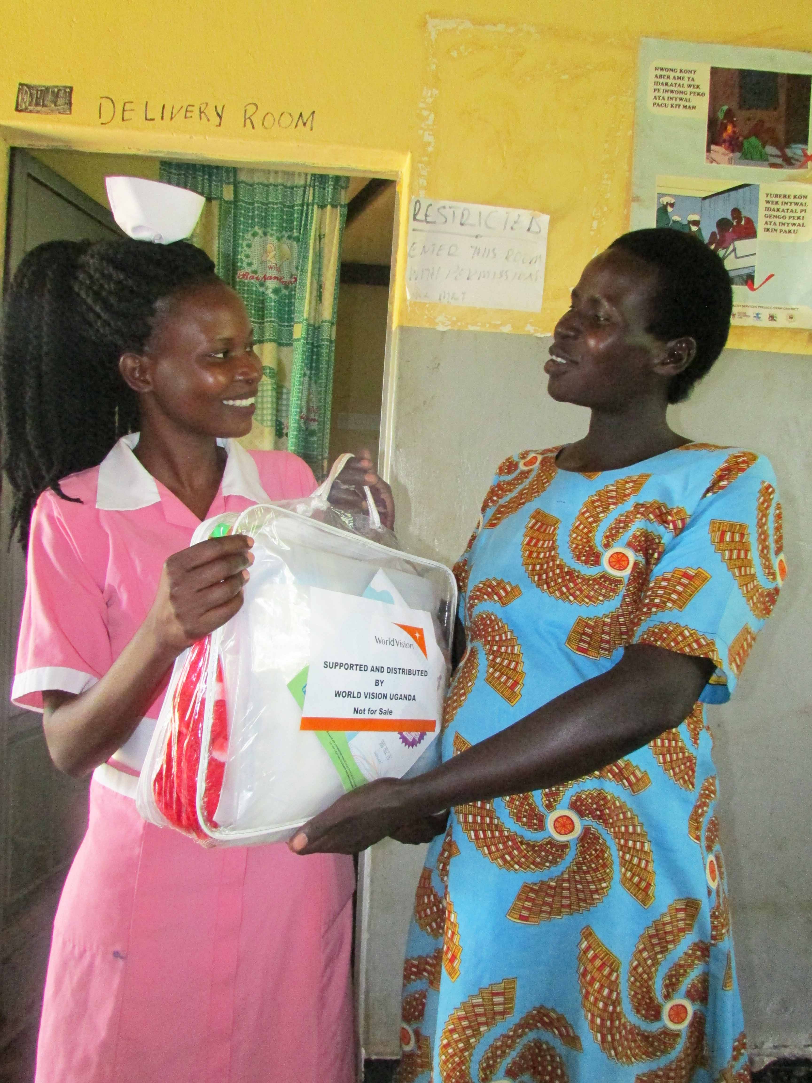 Midwife giving out mama kits 