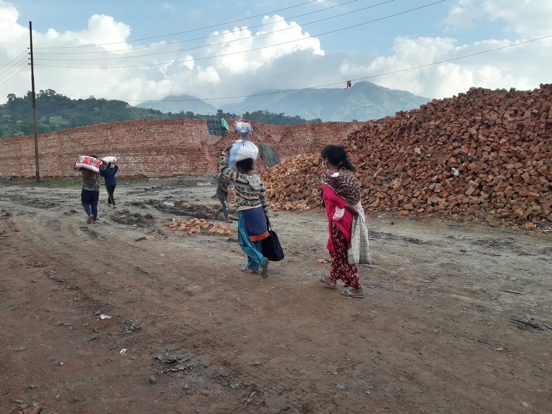 Beneficiaries return carrying the ration supported