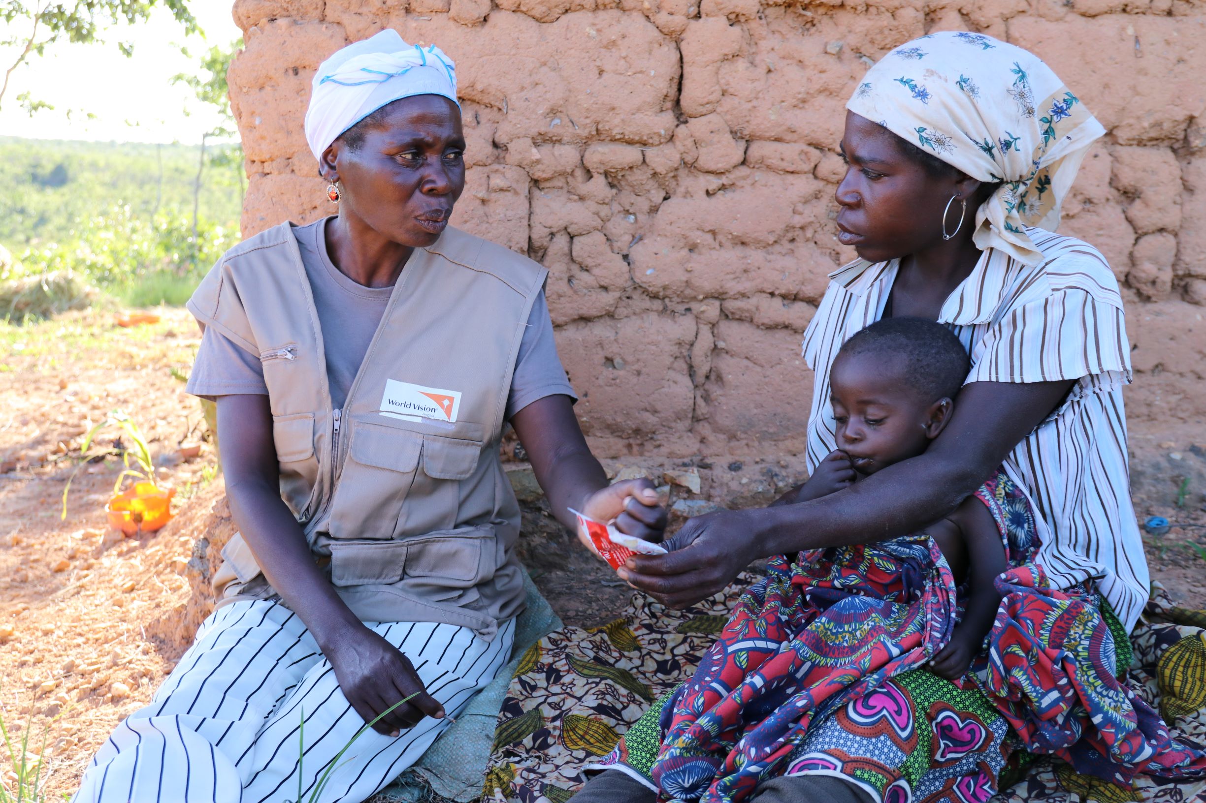 World Vision Community Health Worker explains how to administer Plumpy'Nut