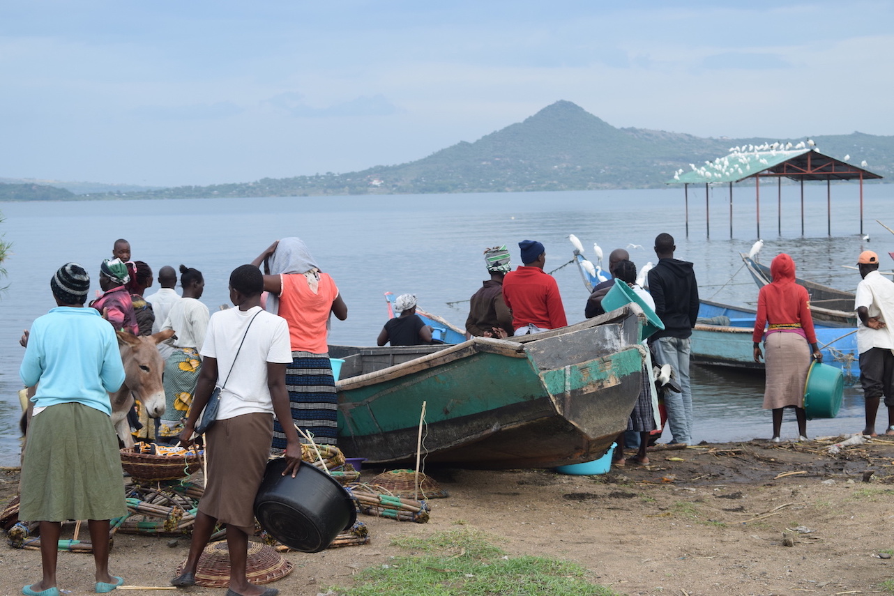 Women waiting along the shores of Lake Victoria to buy fish from fishermen who were fishing during the night in Homa Bay County, Kenya. ©World Vision Photo/Sarah Ooko.