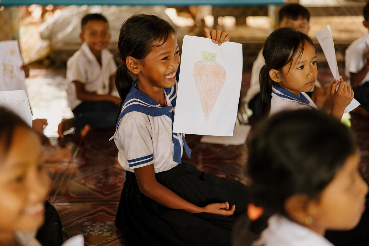 a girl showing her drawing