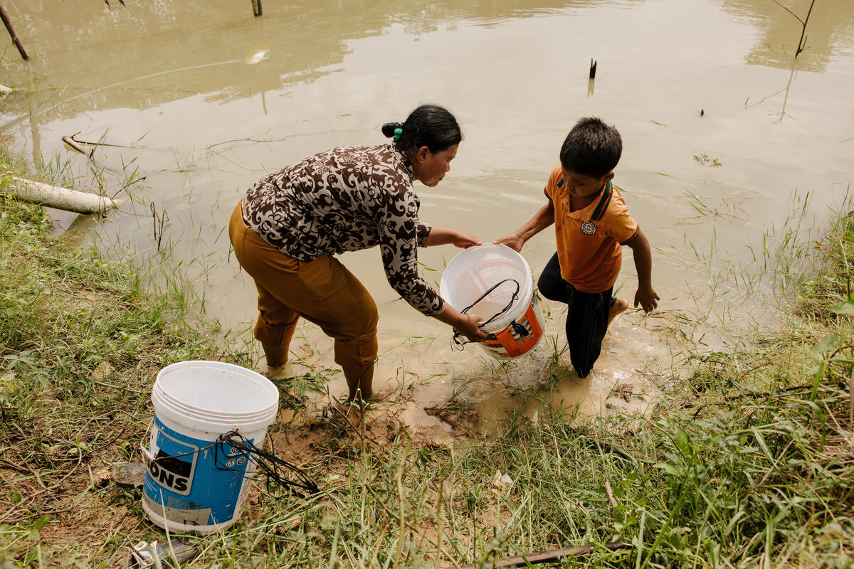 A woman filling water in Cambodia