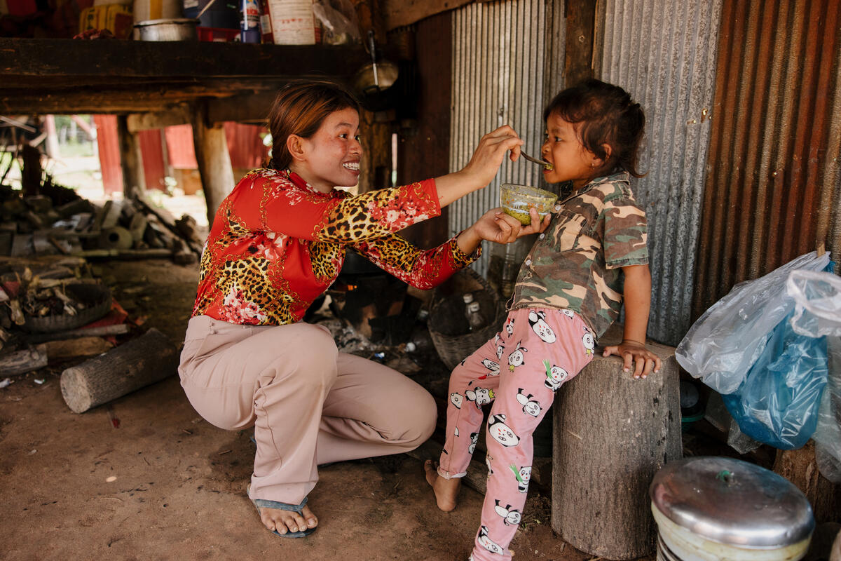 Mother feeds her child nutritious food in Cambodia