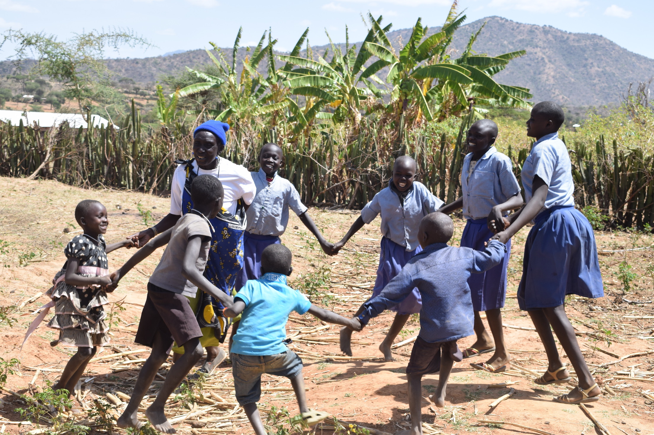 Chepurai playing with her grandchildren at Sook in Kenya's West Pokot County. She has protected them from FGM. ©World Vision/Photo by Sarah Ooko.
