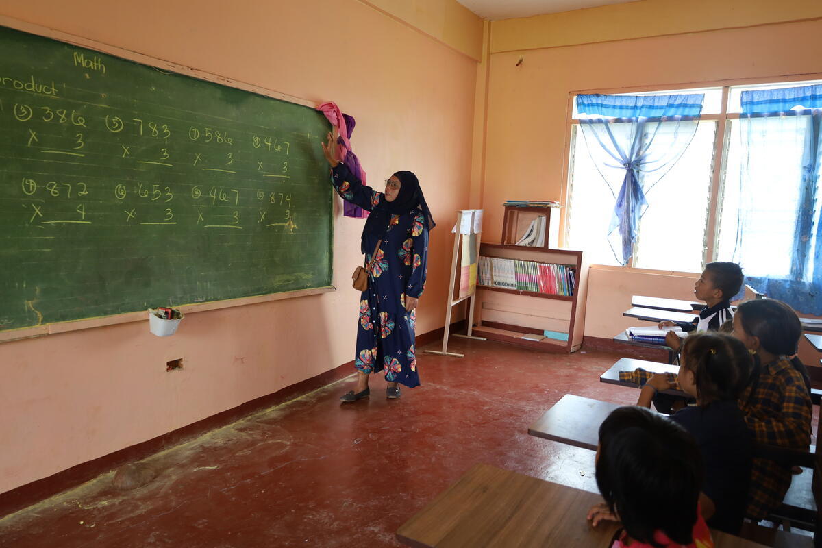  Teacher Rainisah guides her class through some math exercises.