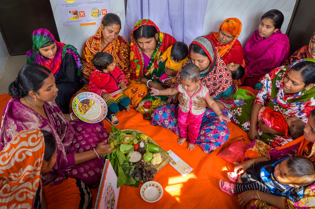 Aparna (left in the purple dress) leads a nutrition training class.