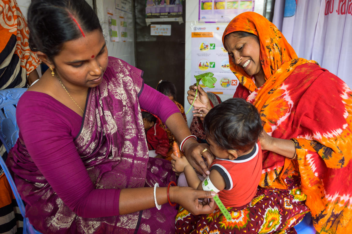 Aparna weighs and measures babies at the clinic.