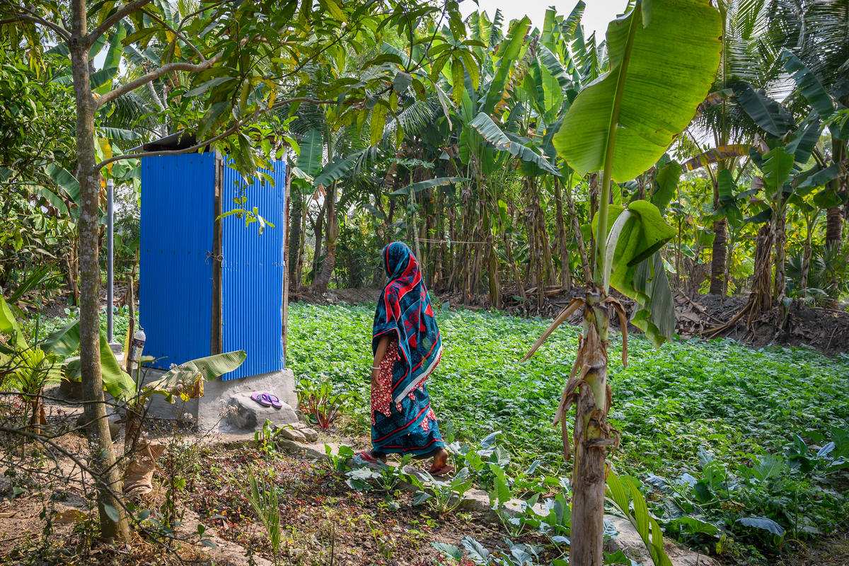 A woman uses a private latrine in Bangladesh.