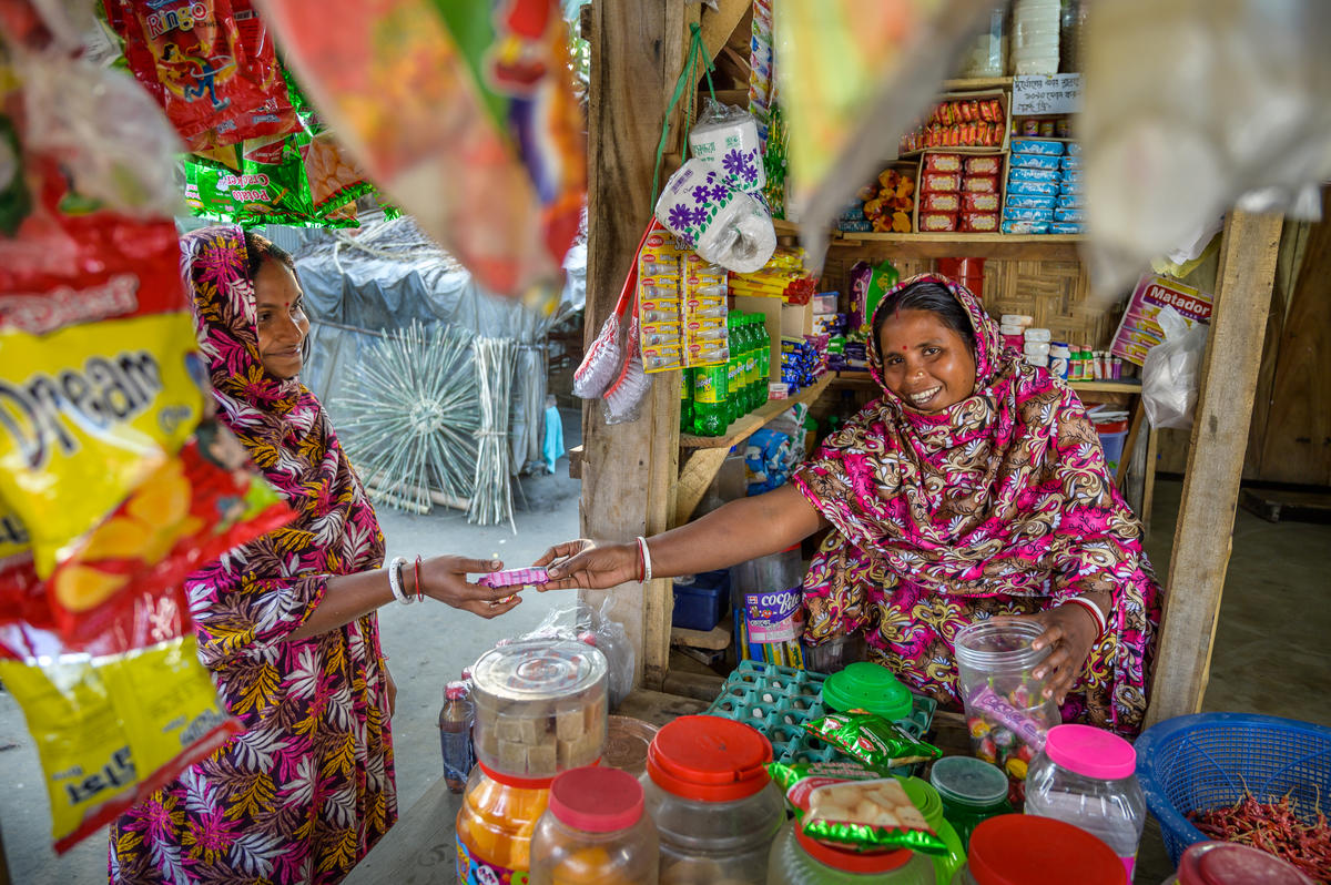 Shabitri makes a sale in her grocery shop