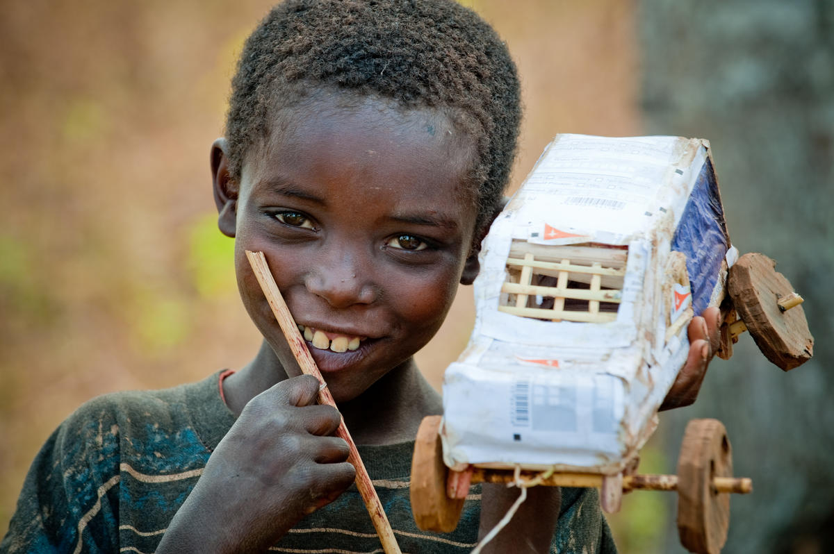 Child in Burundi with homemade toy