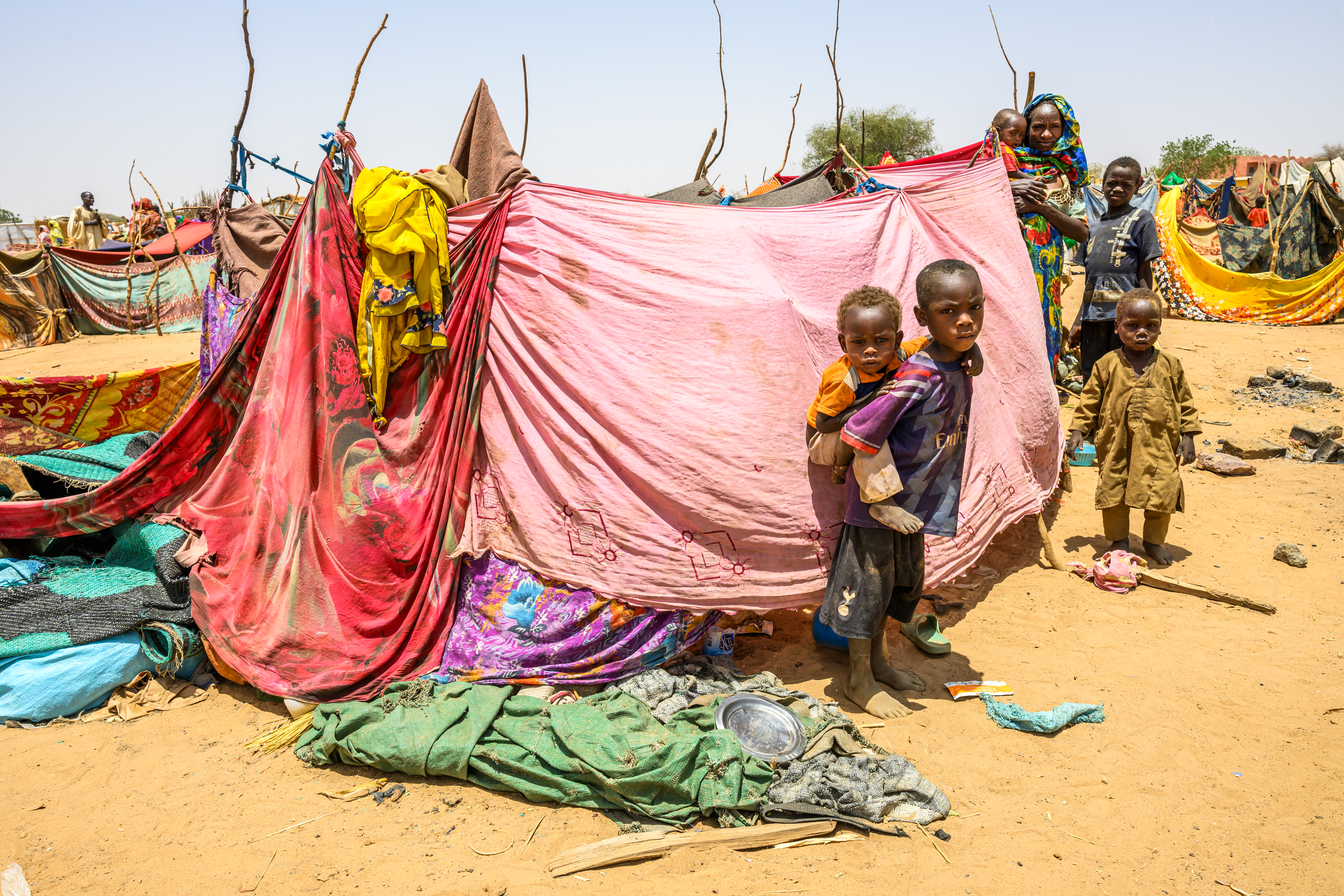 Makeshift shelters at Adre Spontaneous Settlement, where Sudanese refugees endure harsh conditions and severe food shortages.