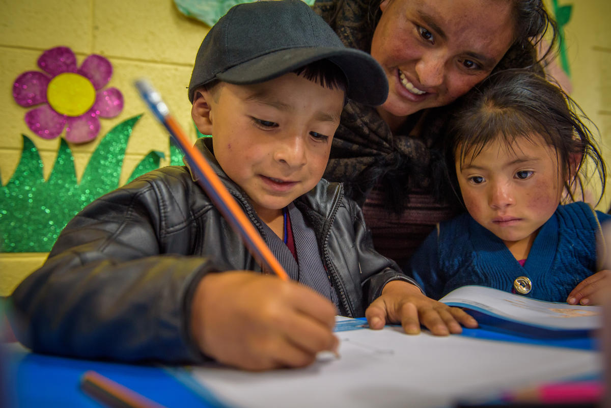 Child writing letter to their sponsor