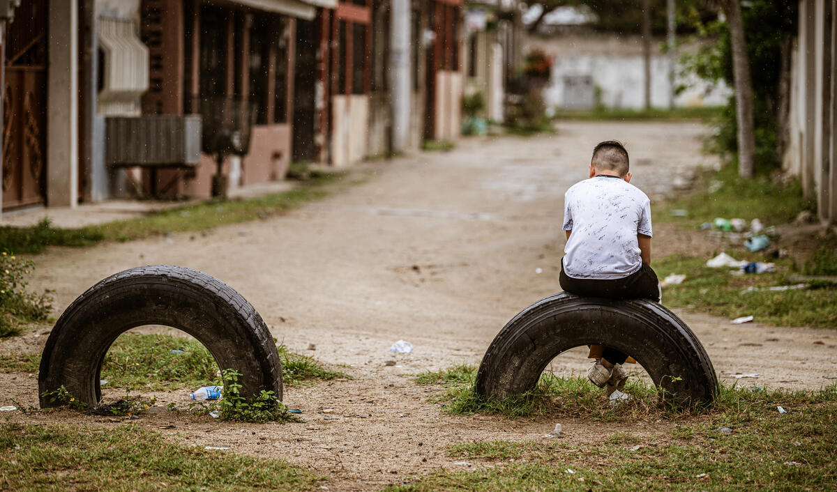 Child sitting on a tyre