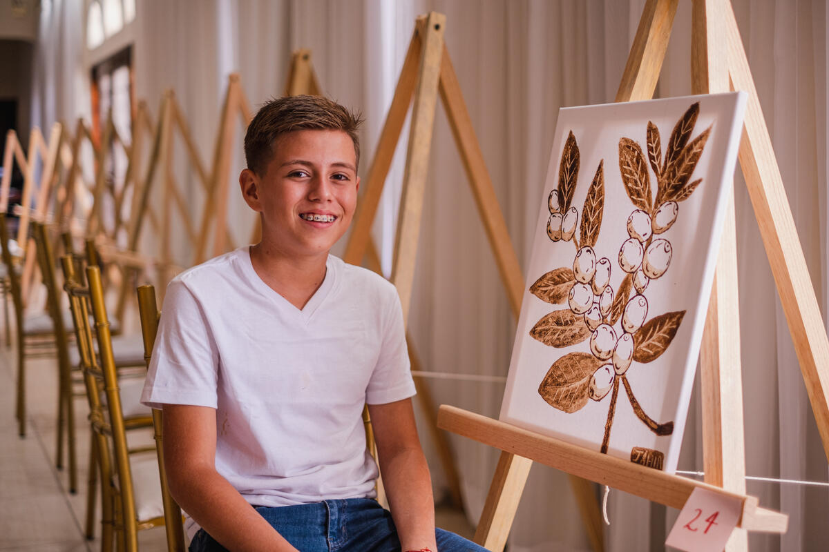 Children who attend the workshop learn art techniques while painting with coffee.