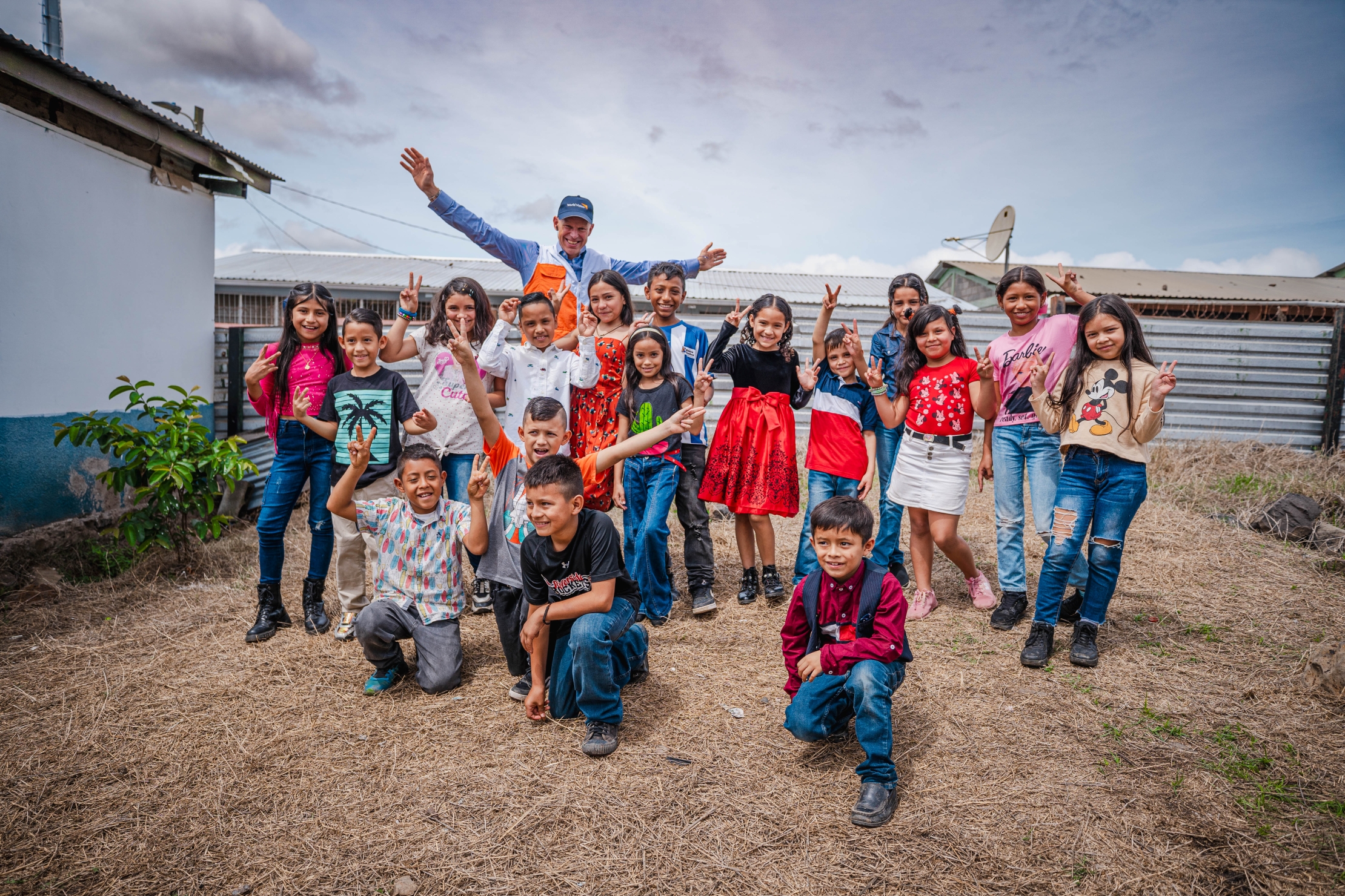 Andrew Morley plays with children during his field visit to World Vision Honduras.