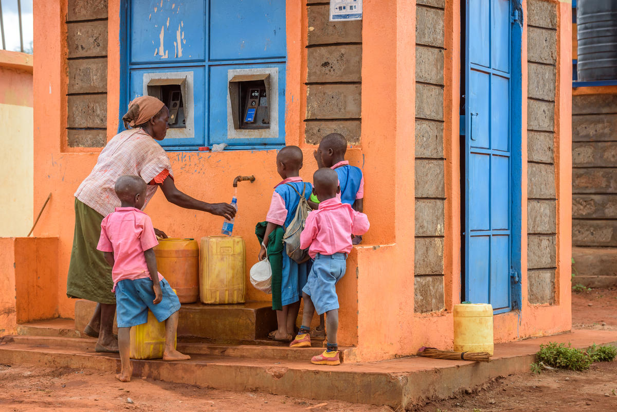 Family using water kiosks