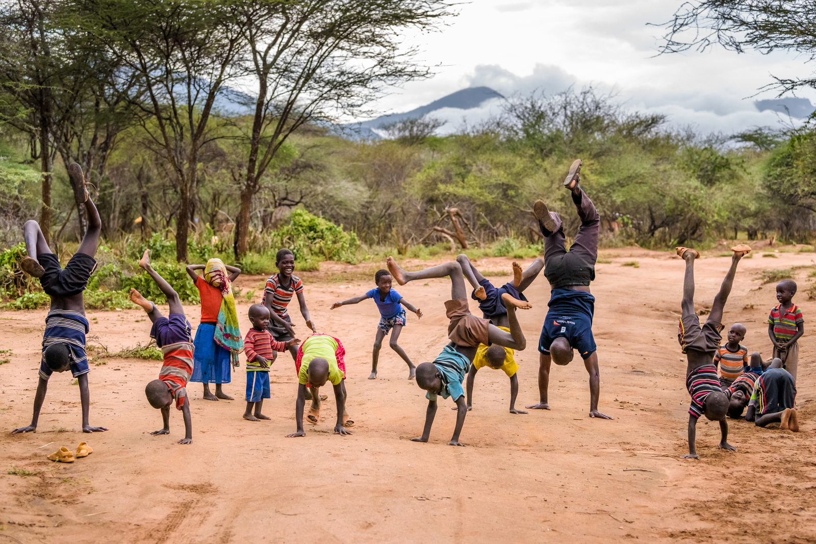 Children in Kesot village do handstands, joined by Charles Kakiti, a World Vision water engineer. Charles wears his Global 6K for Water T-shirt. Touched by the generosity of donors who funded the Kesot water project, he ran the Global 6K to help bring clean water to children in other parts of the world.