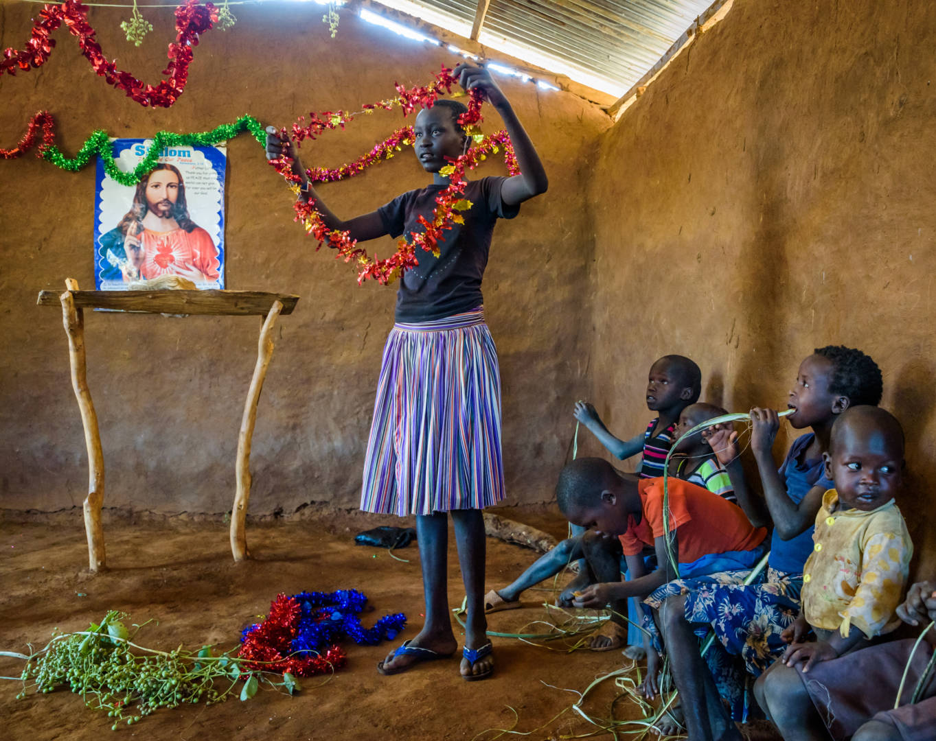 Children, including Cheru (in orange), come early to decorate the church. Before World Vision’s water project brought clean water close to their homes, families sometimes came to church late, dirty, and tired from carrying water. 