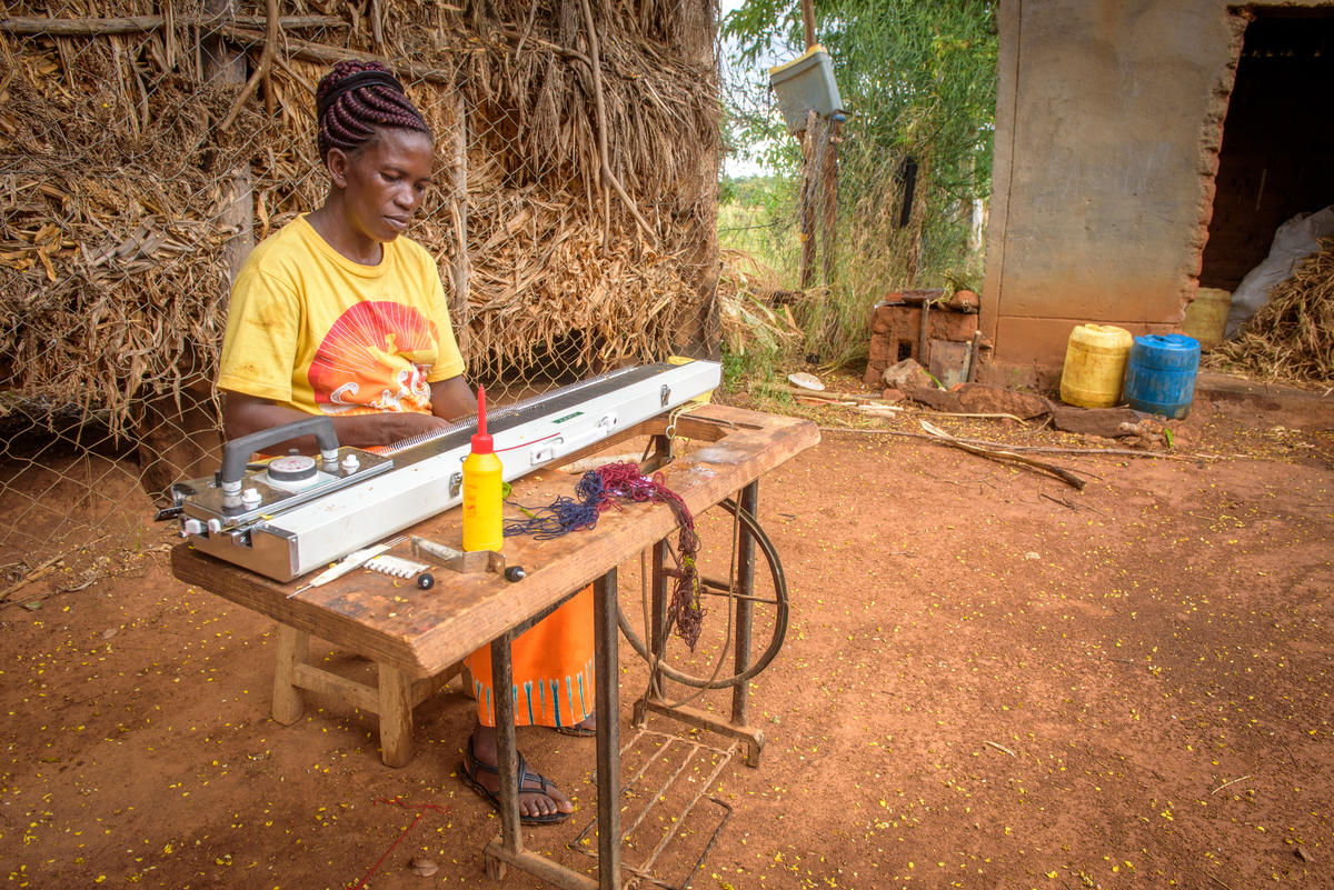 Janet now makes school uniforms at home and is able to provide for her daughter's needs