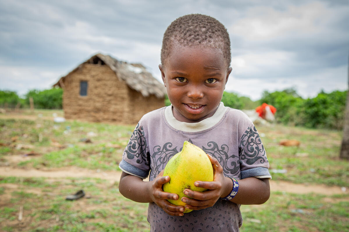 Ramsey eats a ripe mango at his home in Kenya.