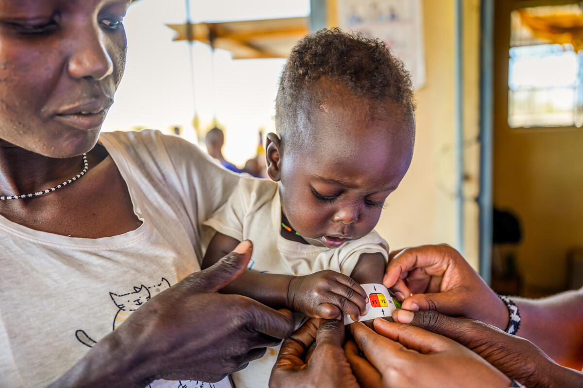 Child having his/her arms measured