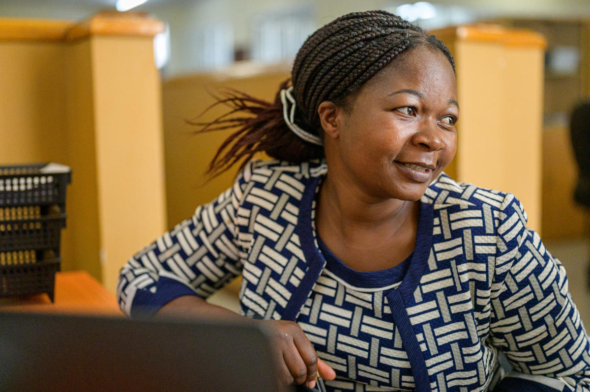 Liddah sitting in her office in Malawi
