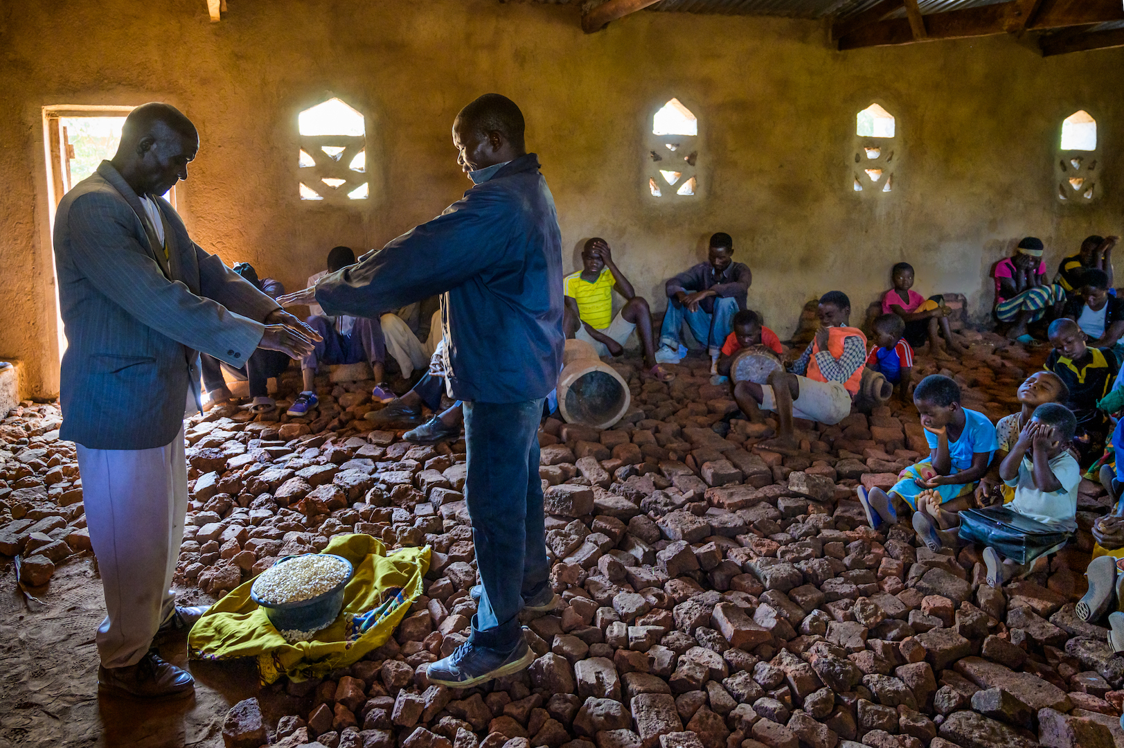 Ireen finds strength at church through prayer and watches as the first maize of the season is blessed as an offering. 