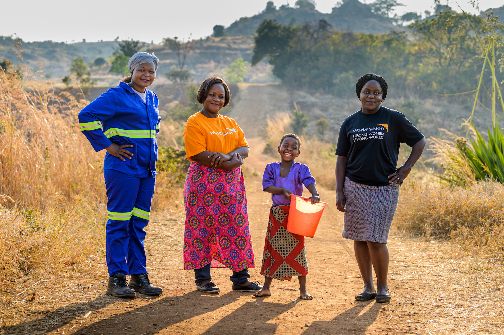 Strength also comes in the form of World Vision staff Liddah Manyozo, Mereena Mhone John, and Irene Chongwe (left to right with Ireen), who are coming alongside her family to promote change through clean water and sponsorship. 