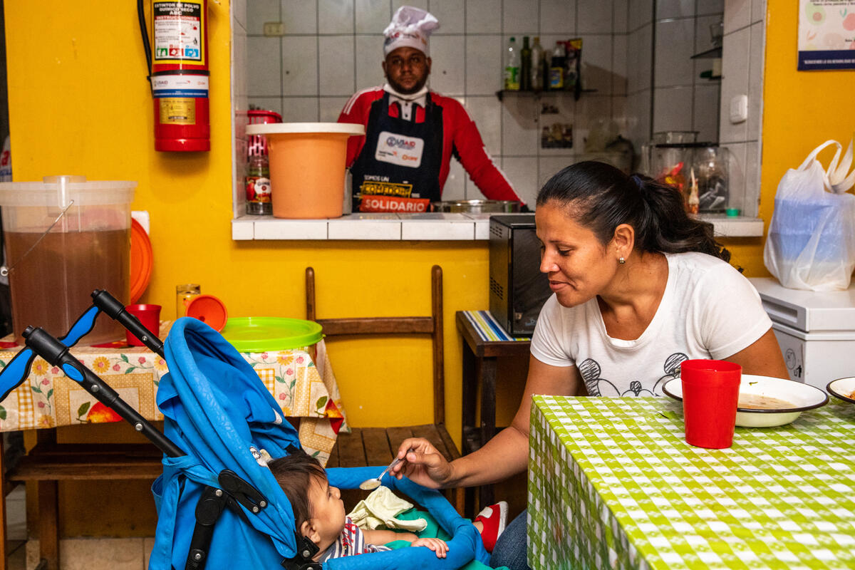 Venezuelan Refugee feeds her baby at feeding center