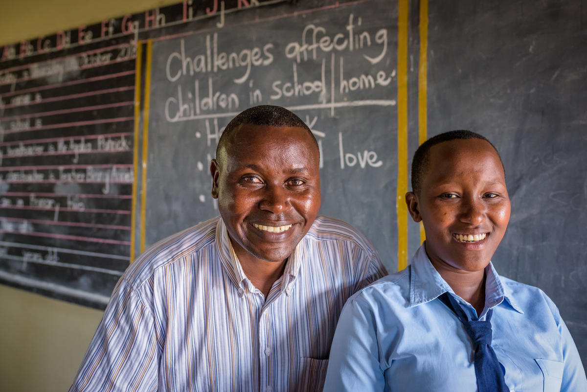 Janet with her school teacher who helped her avoid child marriage