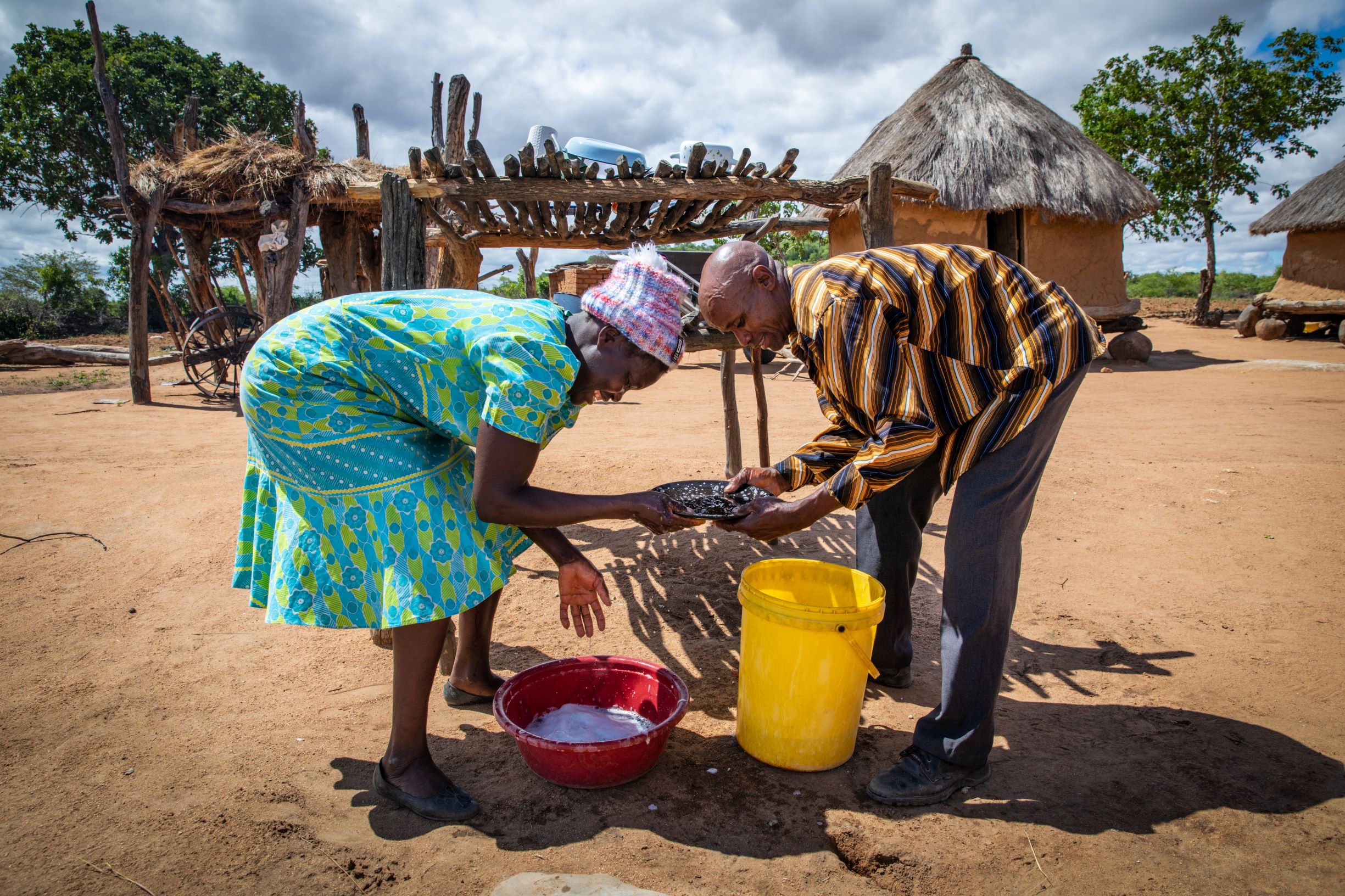 two people washing plates