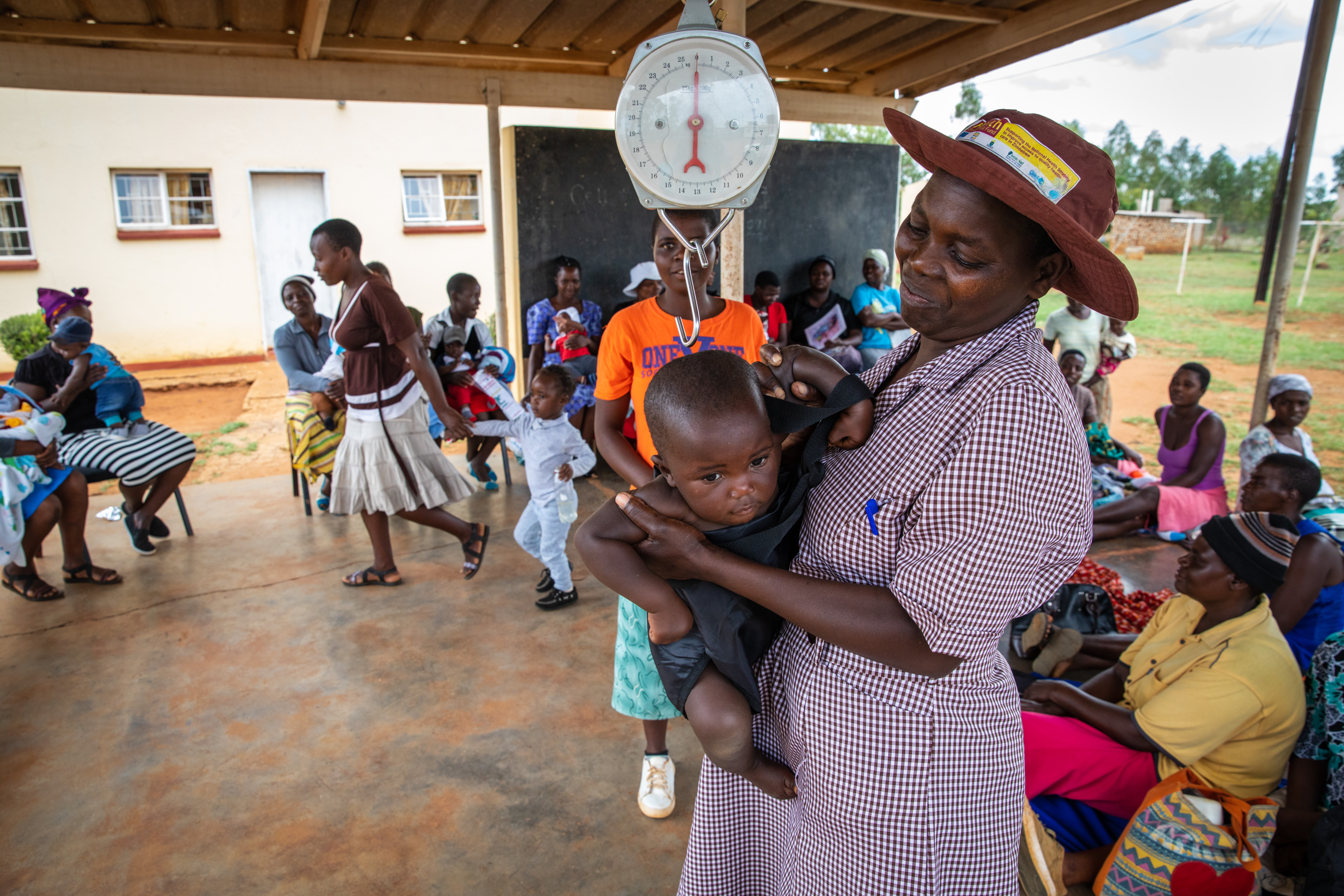 A woman weighs a baby in Zimbabwe