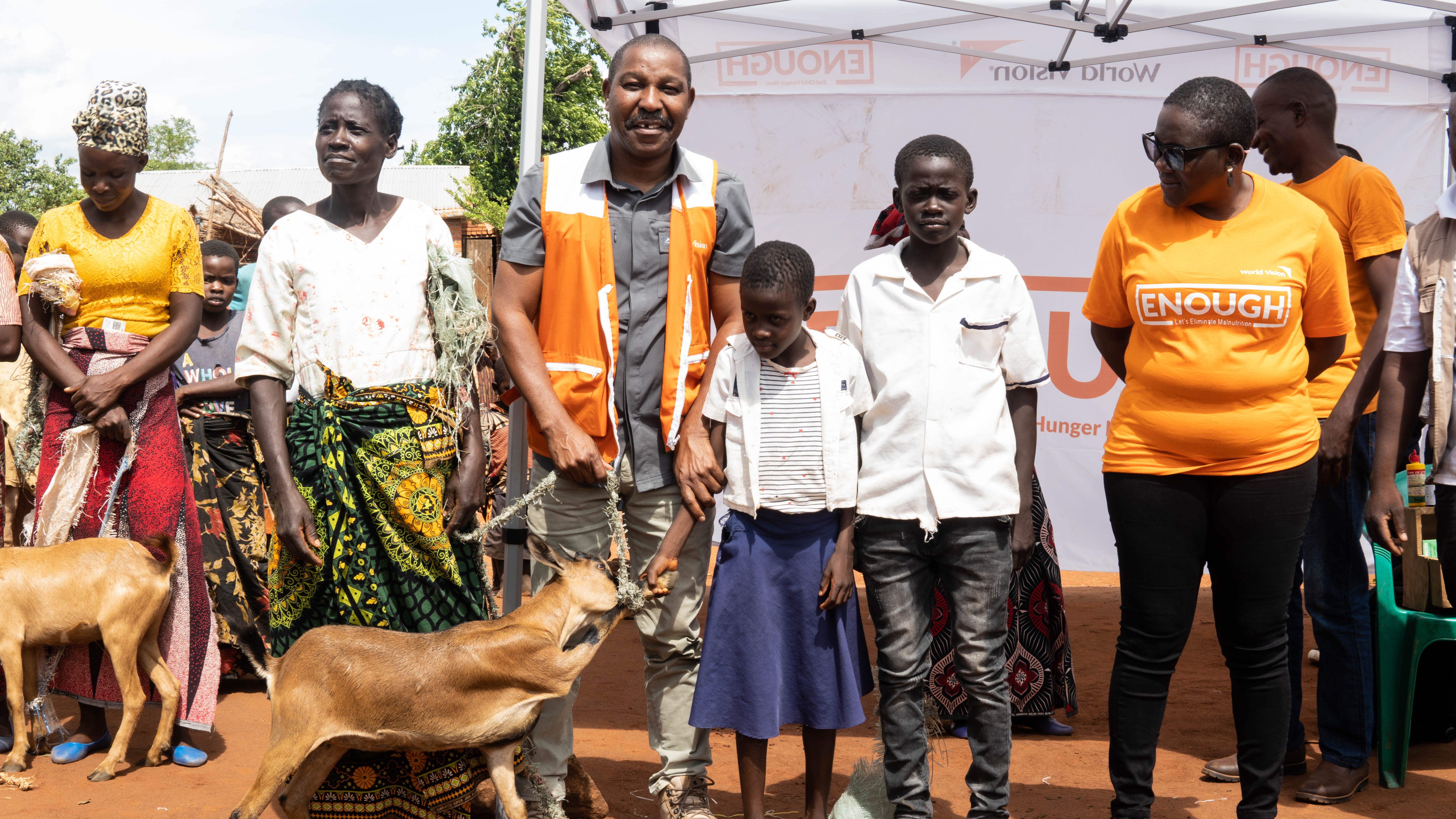 World Vision Malawi Director of Operations, Chimombo in the middle with some beneficiaries of the goat pass-on project and World Vision Livelihoods and Resilience Technical Program Manager, Asimenye Chitika at the far right.