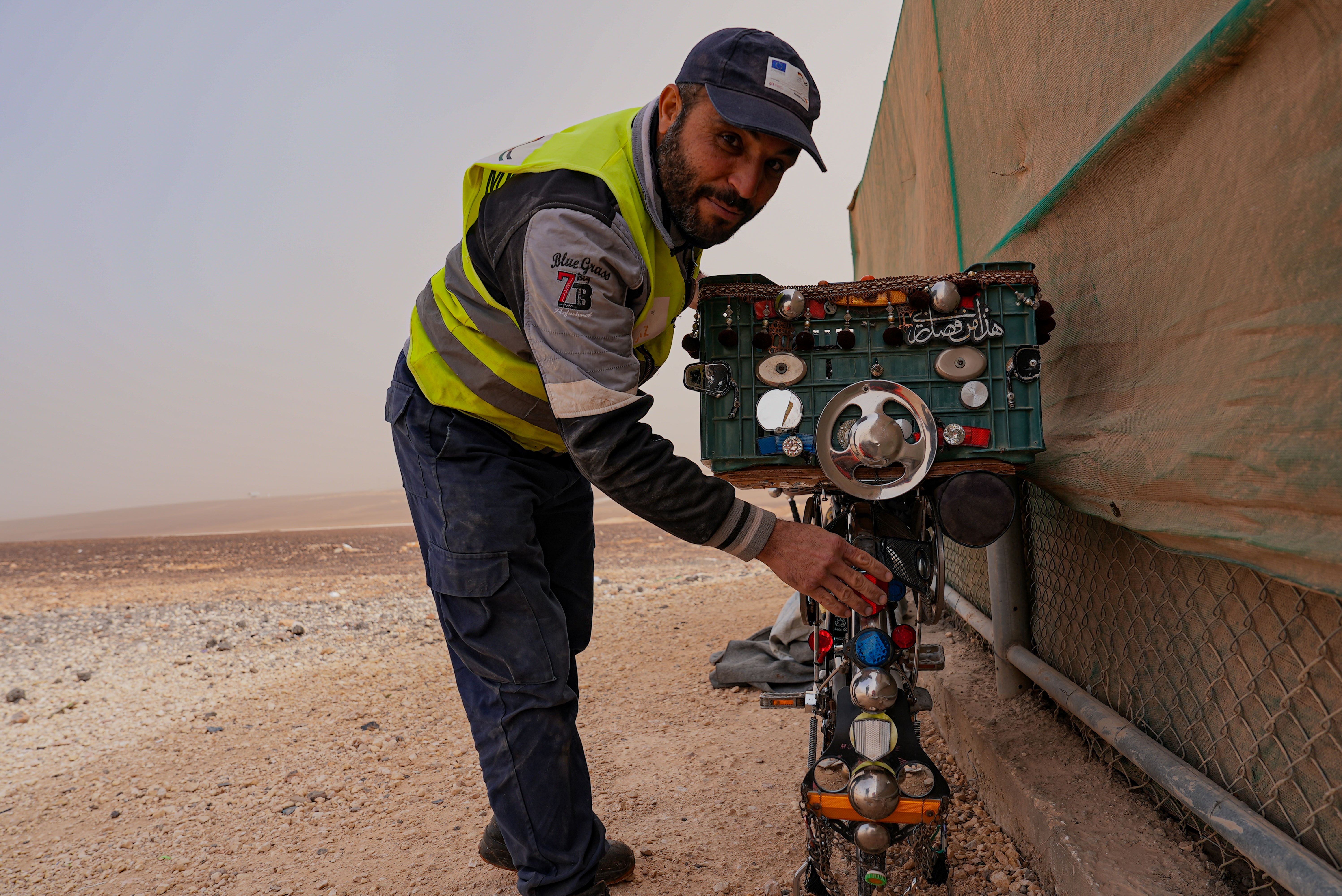 Mohsen proudly shows his bicycle which operates on solar power