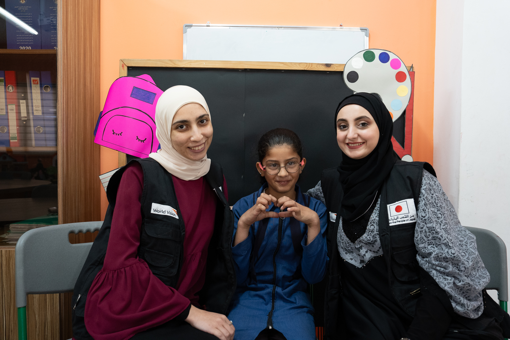 Dana happily posing with her teachers World Vision Syria Response, Joanna Zreineh