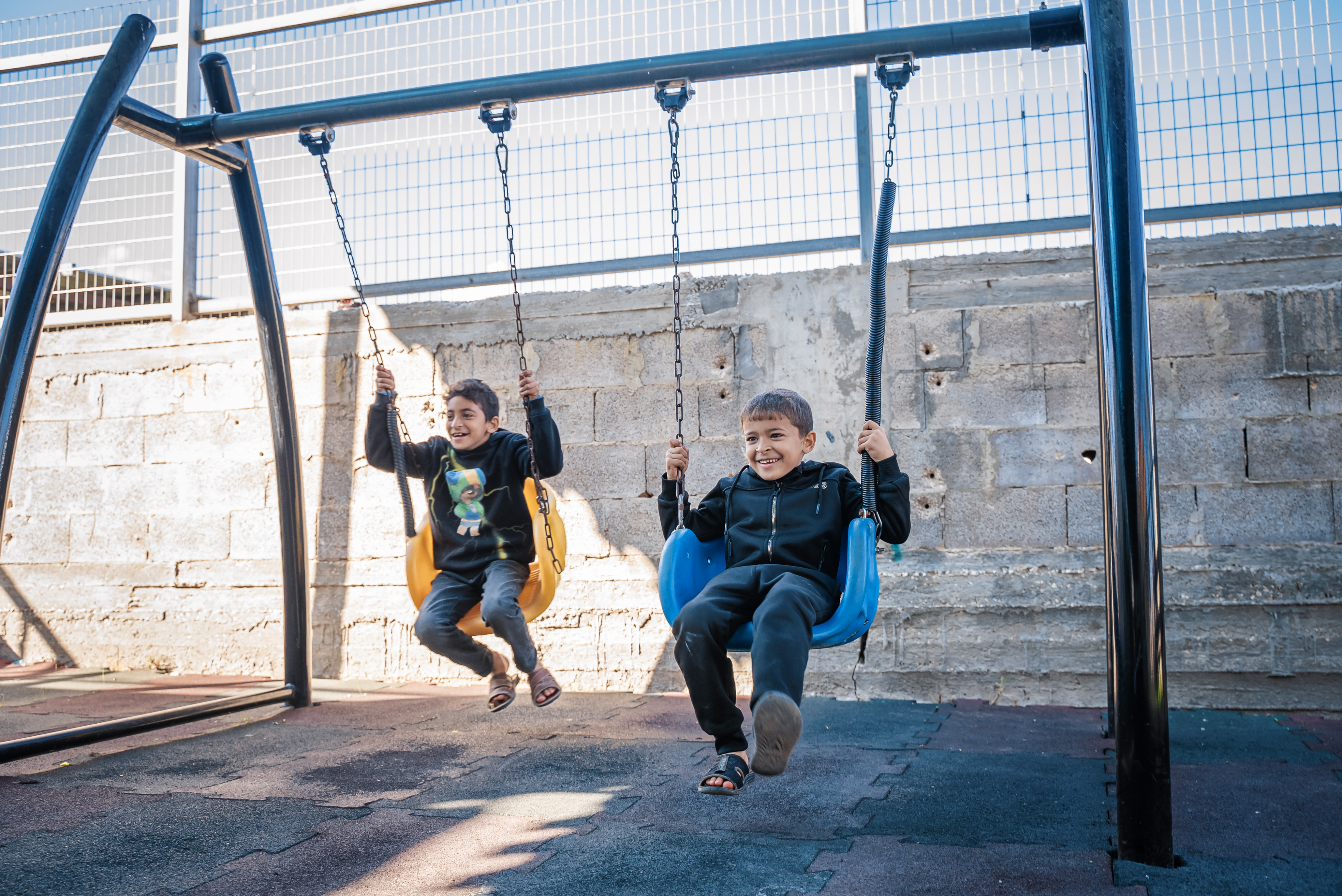 Children plays in a playground recently renovated through the project.