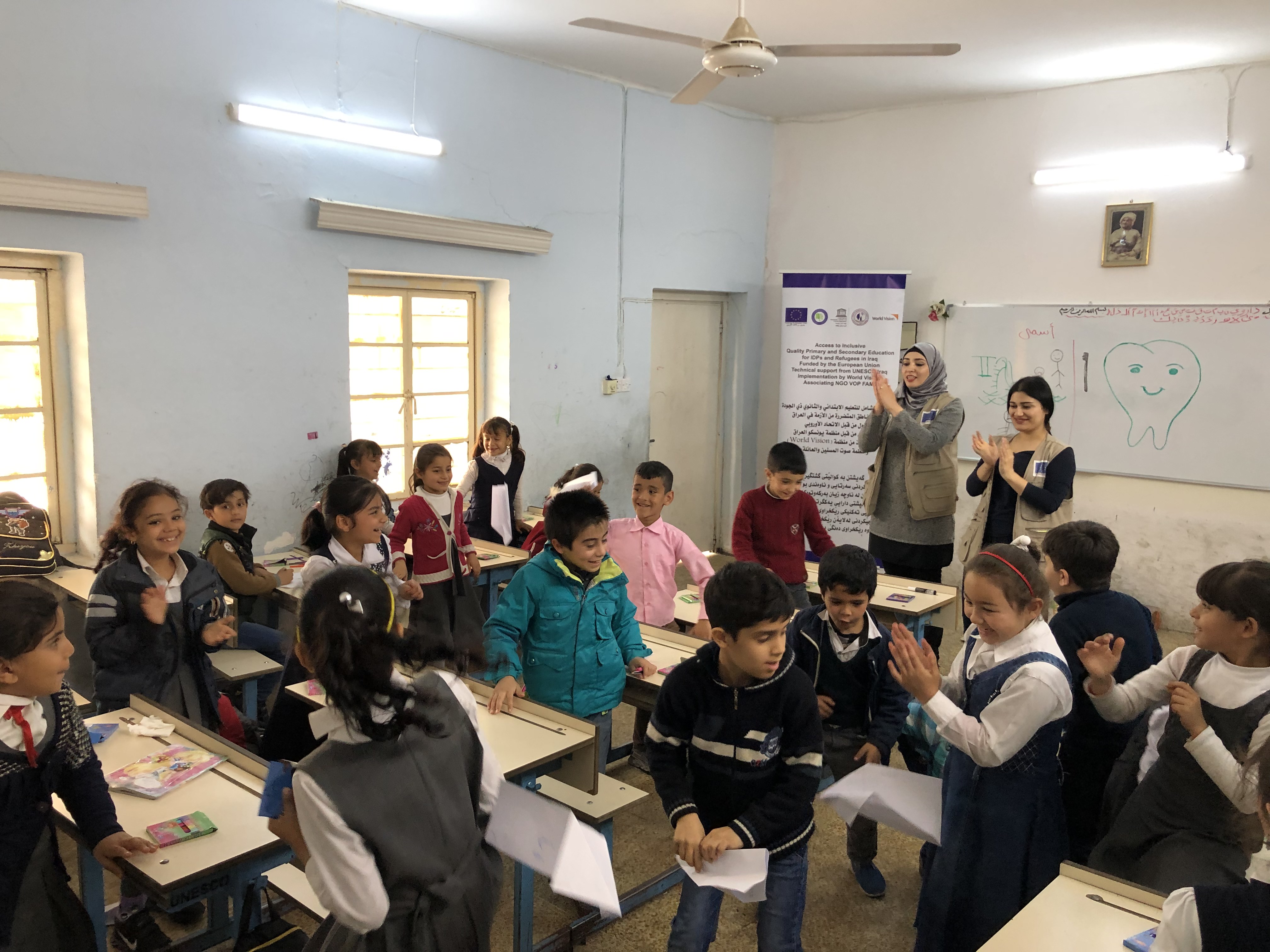 Children flying their paper planes to get rid of negative feelings as part of the psychosocial support session at Al-Elm Al-Nafe’e Primary Coed School for IDPs in Erbil, Iraq