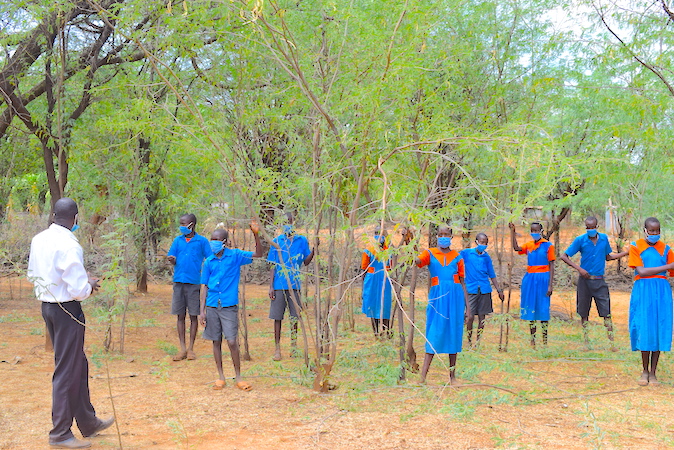 Teacher Raymond, inspired Stella and other children to conserve the environment by planting trees. 