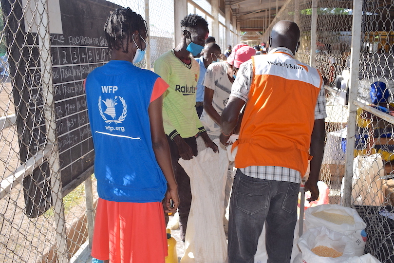 World Vision and WFP staff giving refugees food items at Kakuma Refugee Camp in Kenya.