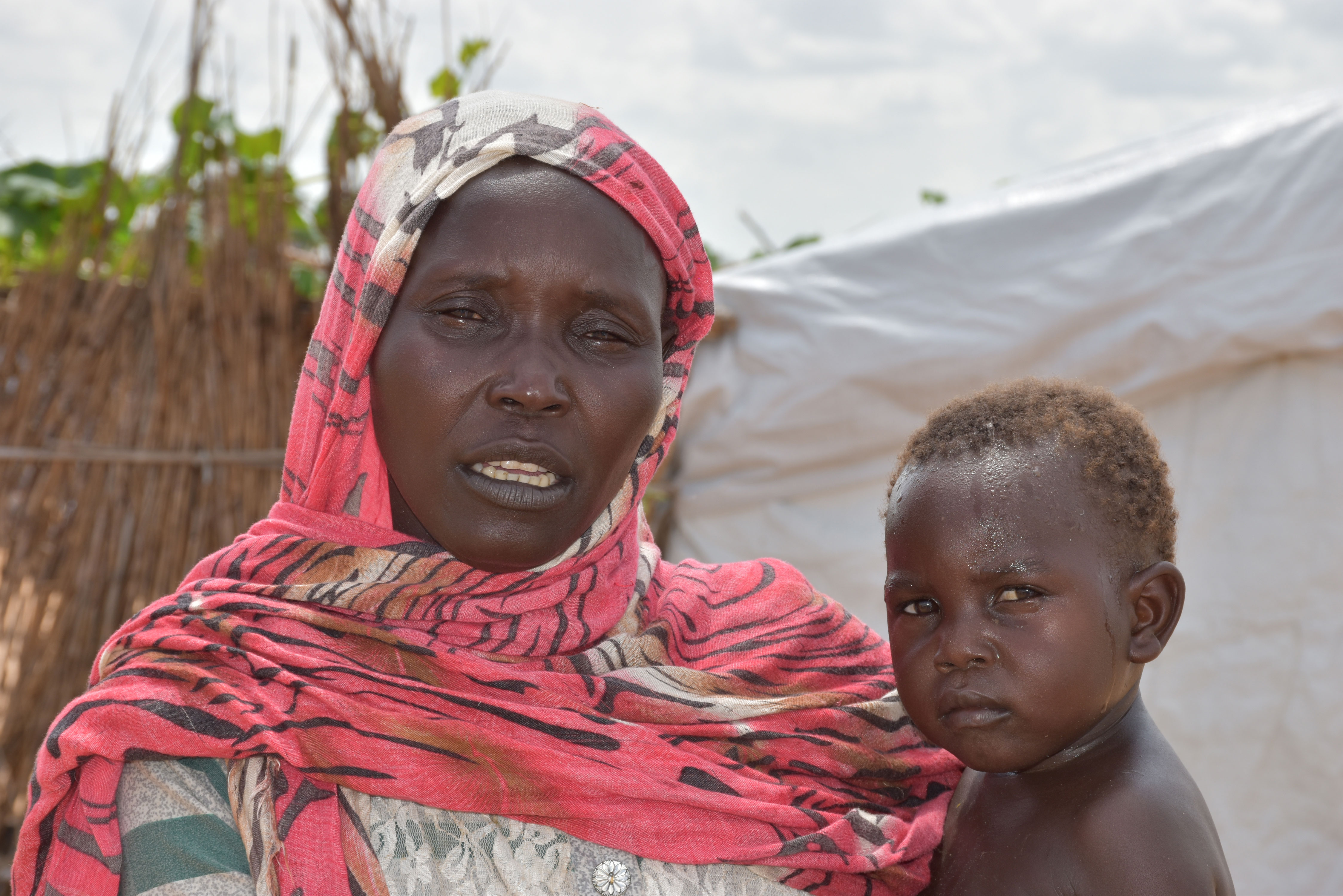 35-year-old Salwa Ramadan is a refugee from South Sudan works with her family to reconstruct family’s shelter