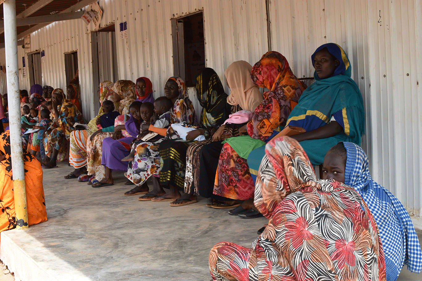 Patients wait to receive free medical consultation at the Otash clinic run by World Vision.