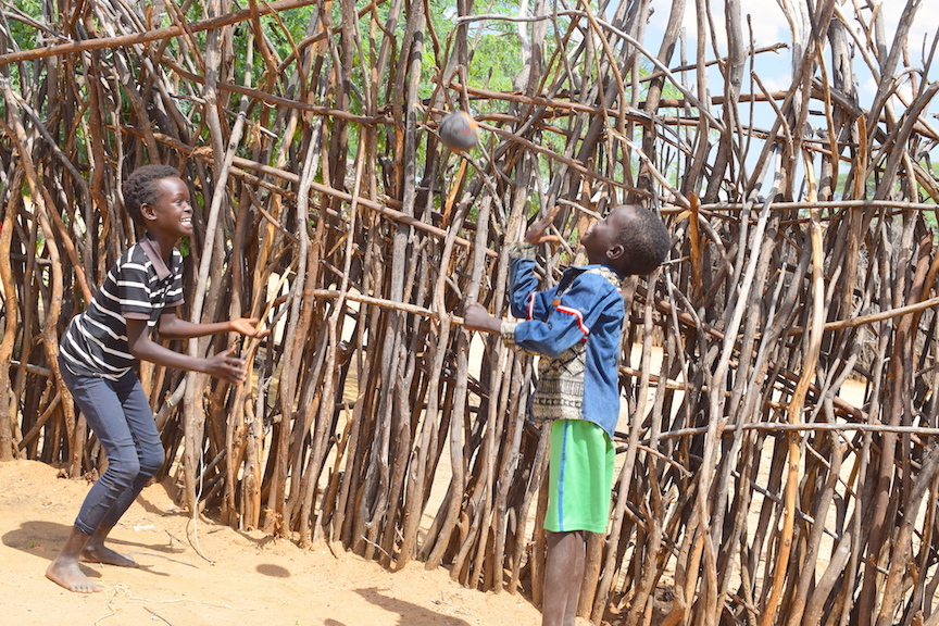 Joyce playing with her brother. They can now enjoy all basic needs