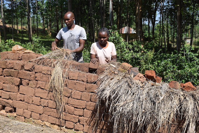 Annah with one of her employees assessing dry bricks that are ready for the market at Nyamusi, Kenya. ©World Vision Photo/Sarah Ooko.