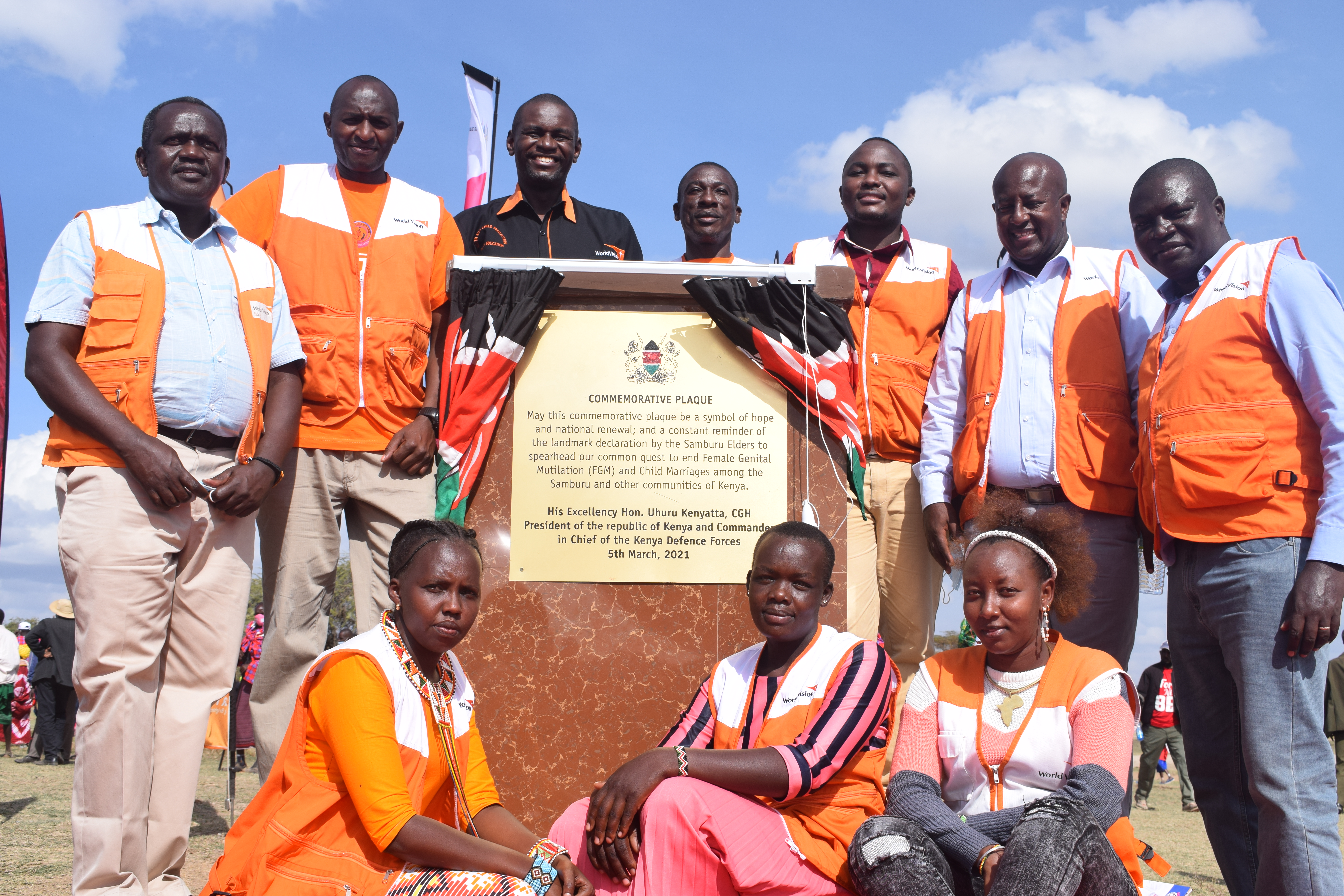 World Vision staff at the Kisima Declaration Commemorative Plaque. Elders from Samburu, where the FGM prevalence rate is 86%, made a declaration to #EndFGM and #ChildMarriage in their community