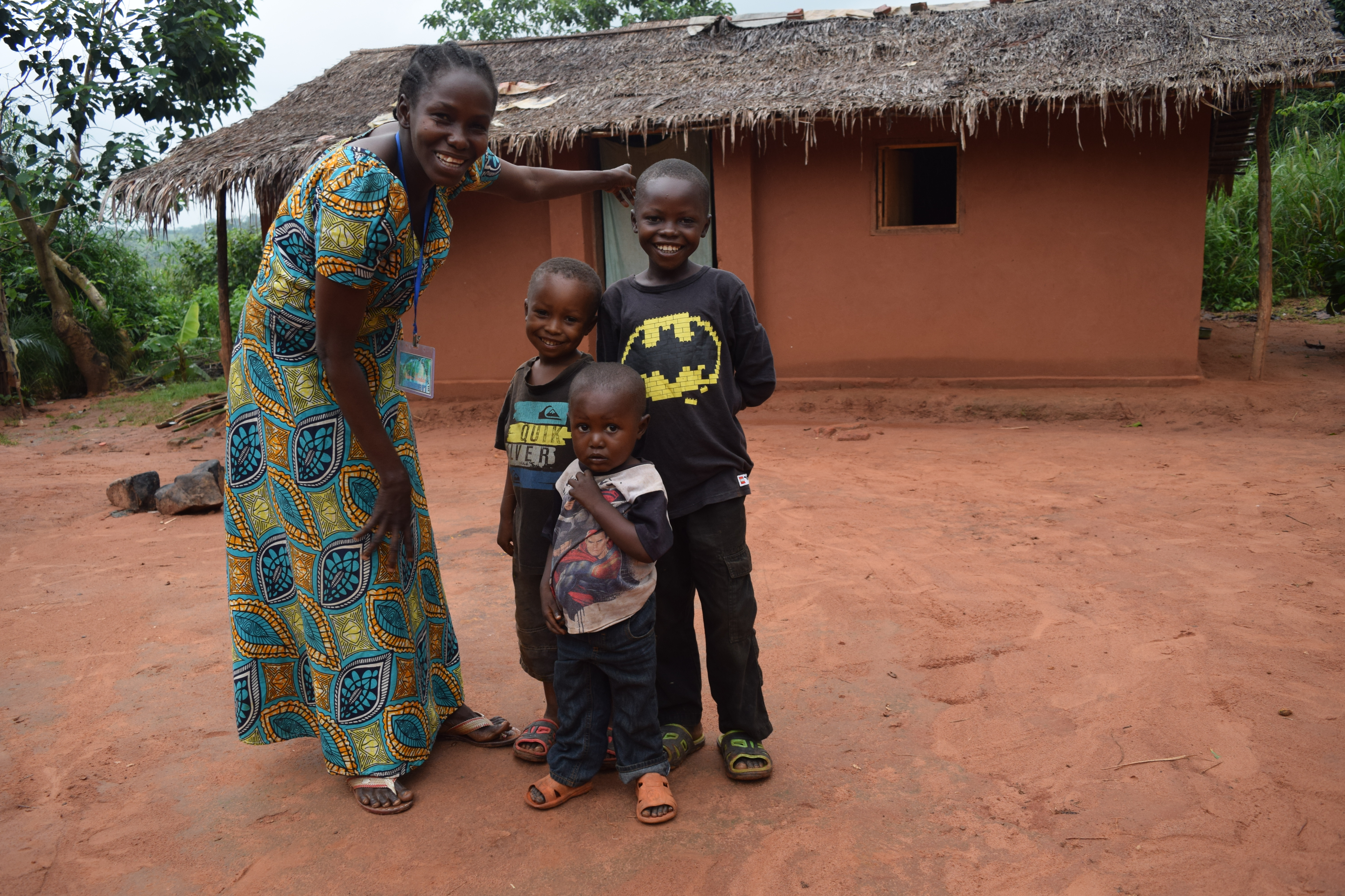 Albertine and her children in front of their new home