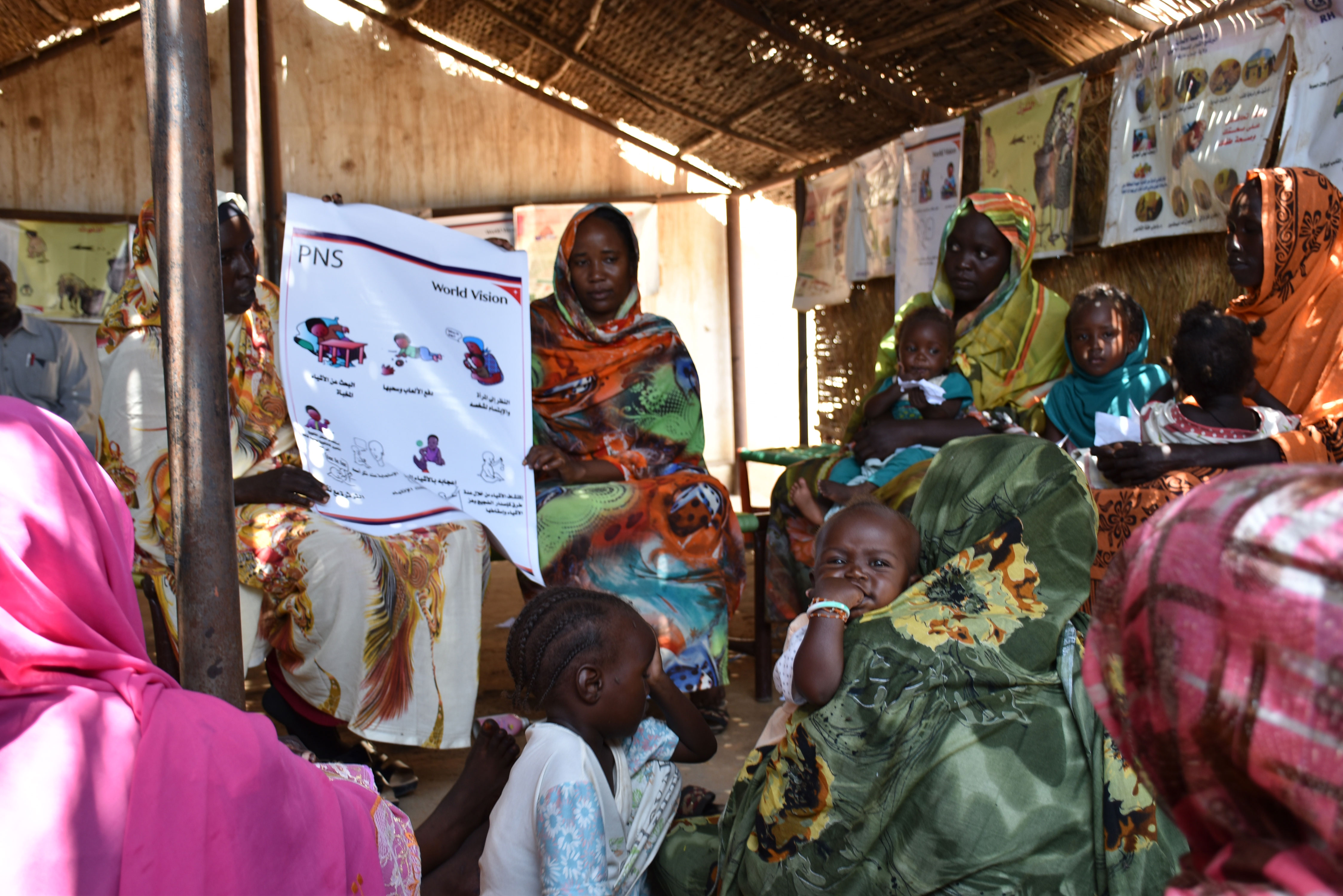 Mothers who bring their children to be treated for malnutrition spend some time in the GBG makeshift playground.