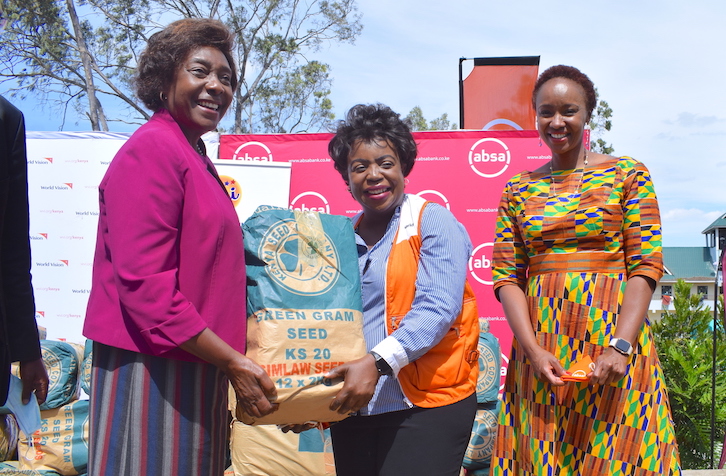 Lilian Dodzo (centre), the National Director for World Vision in Kenya holding a bail of seeds donated to farmers with Charity Ngilu (Governor-Kitui County), Lilian Dodzo (National Director- @WorldVisionKE ) & Caroline Ndung'u (Absa Marketing & Communications Director).