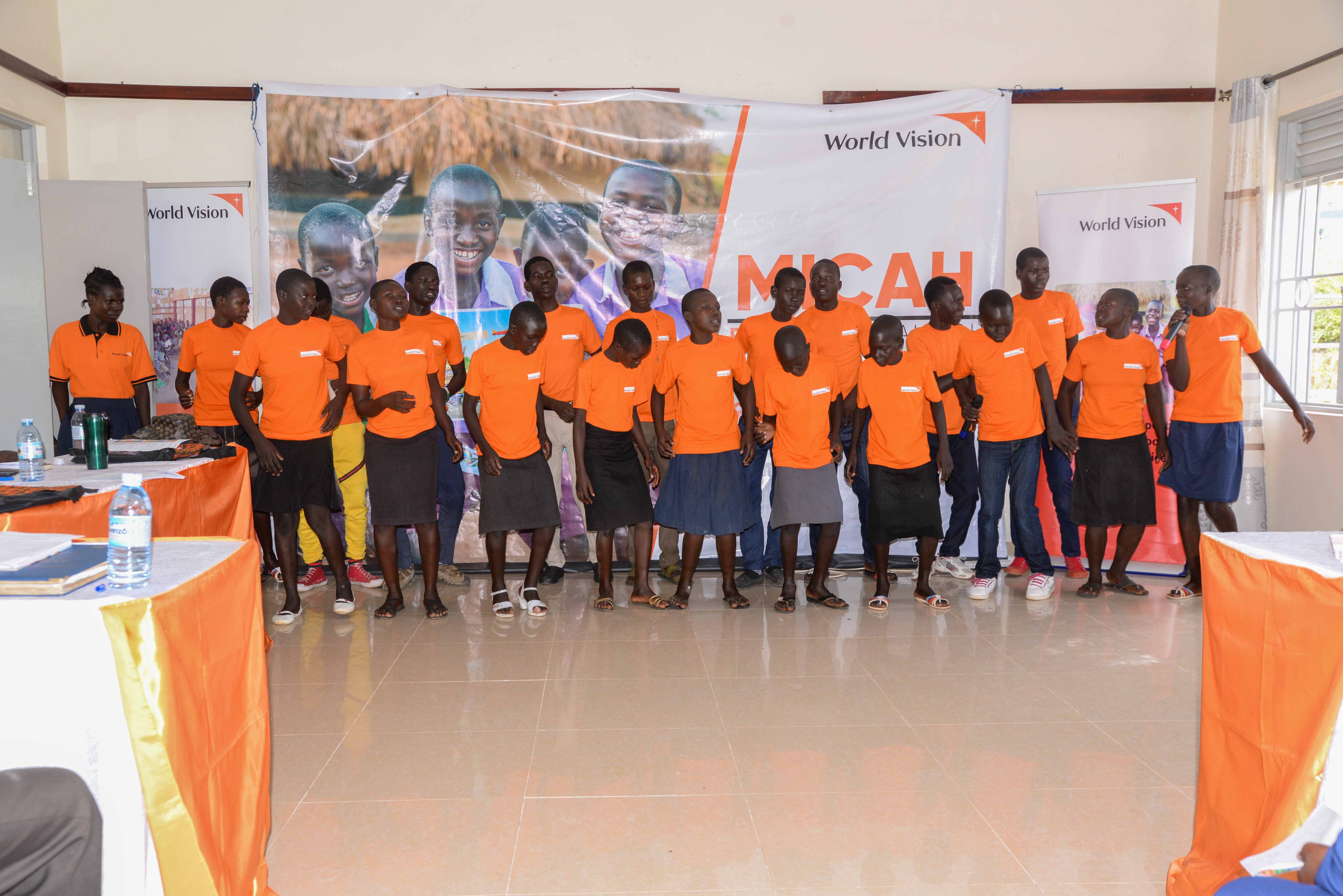 Children from St. Mary’s Child Friendly Space in Omugo sub county presenting a drama and song at the Micah launch