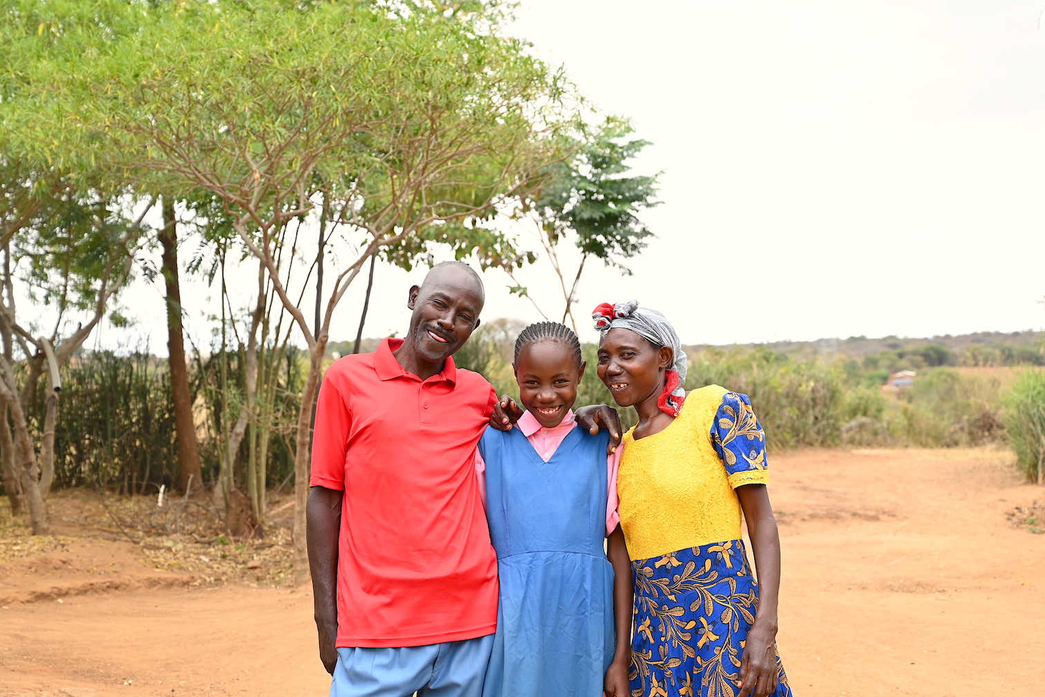 Tom (left) and her wife Teresiah (far right) with their daughter. The Empowered World View training helped in transforming their lives. ©World Vision Photo/Sarah Ooko.